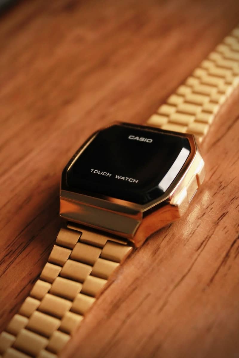 gold link bracelet black and gold square watch